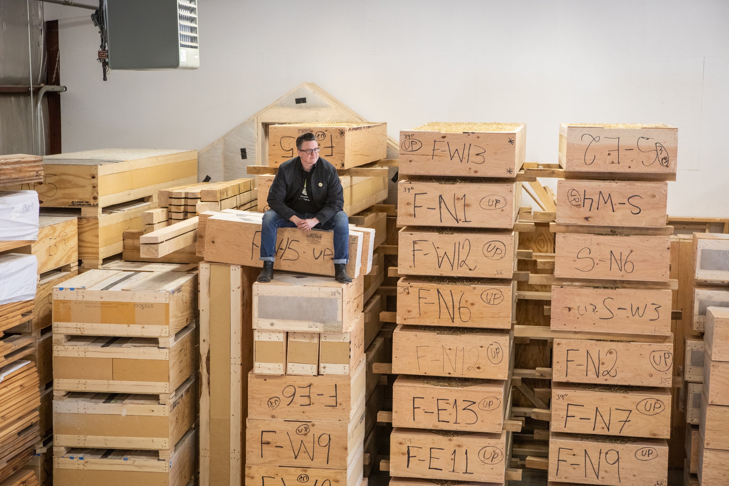 Straw panels stacked and labelled by wall position in the New Frameworks shop in Essex Junction