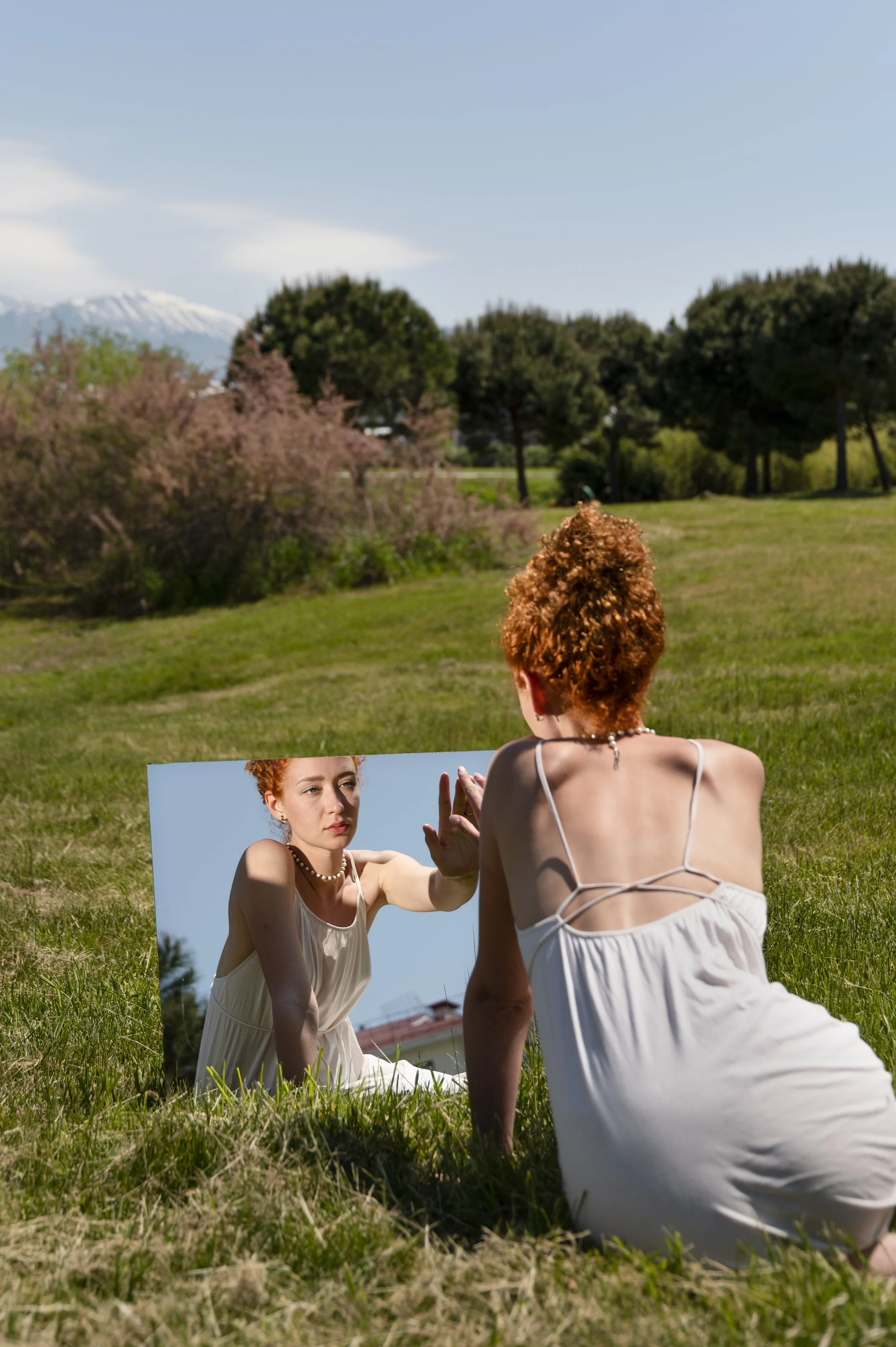 A woman looking at herself in a mirror