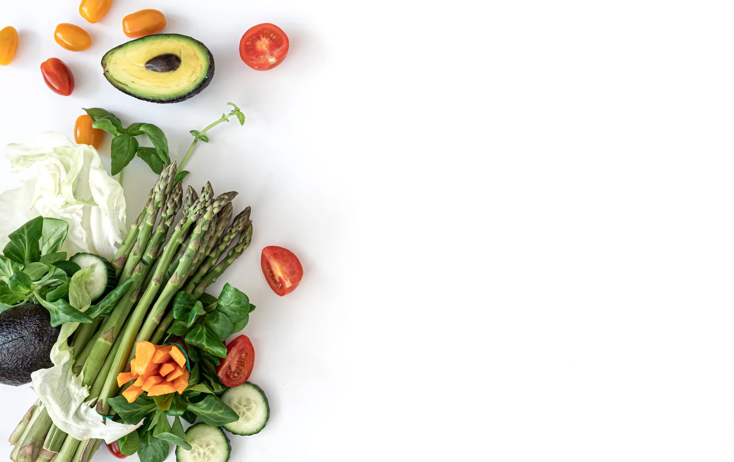Fresh vegetables including asparagus, avocado, tomatoes and cucumber