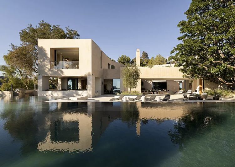White boxy modern with reflecting pool and mature shade trees