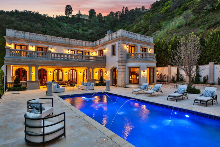 Italianate mansion with fountain-lined pool at night