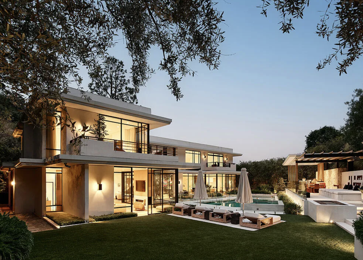 Two-story glass modern with pool at twilight