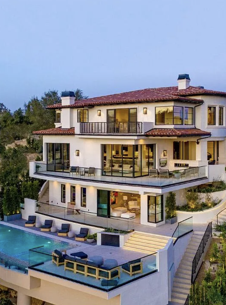 Three-story Mediterranean home with balconies and pool