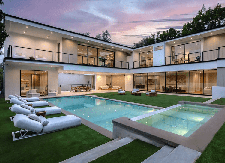 White two-story modern wrapped around a courtyard pool