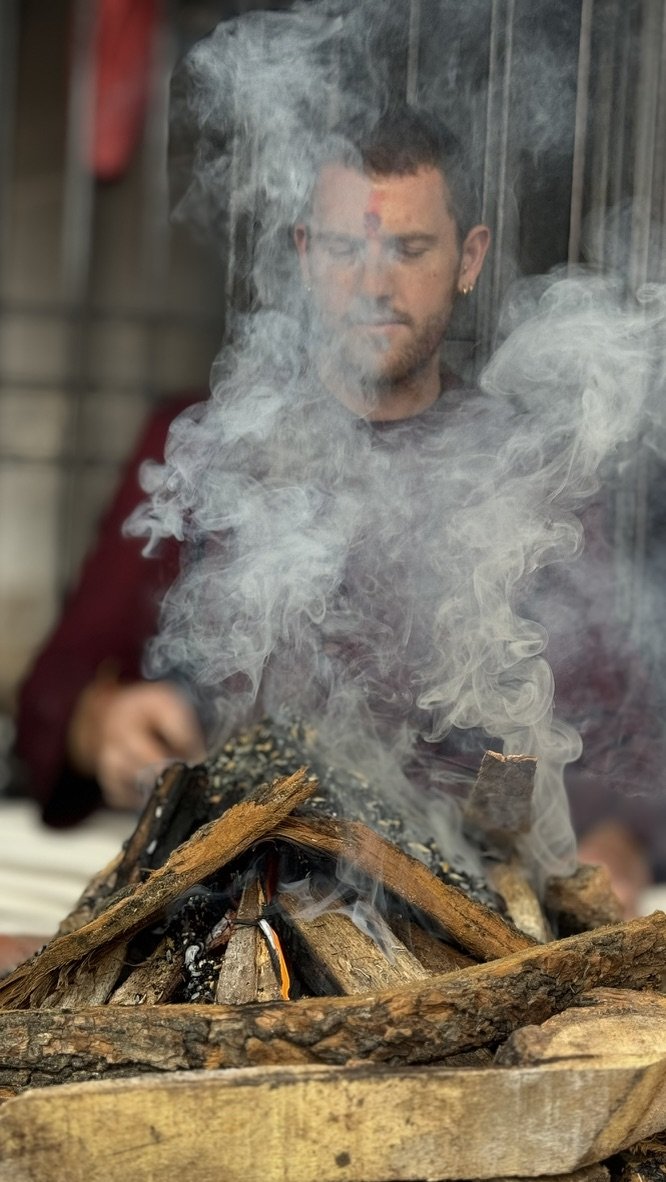 Mike Watts at a fire ceremony, smoke rising