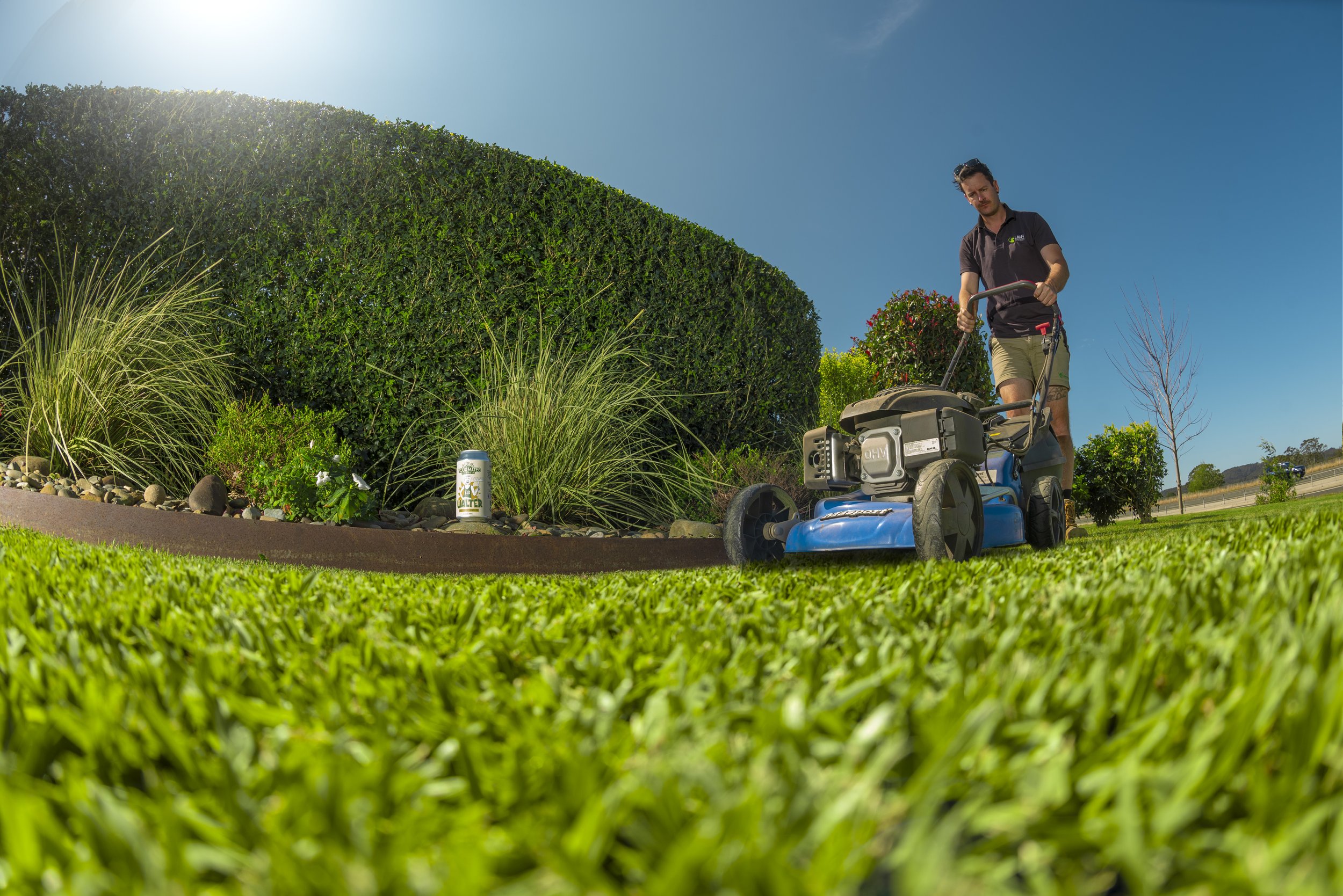 Mowing a Perth lawn in summer