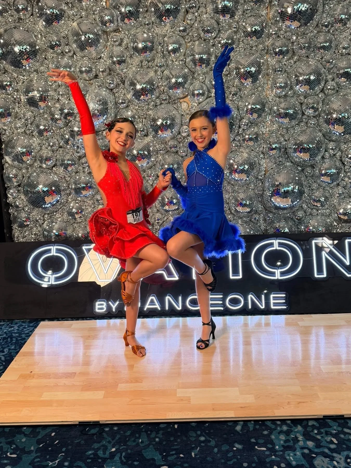Two girls at Ovation competition backdrop