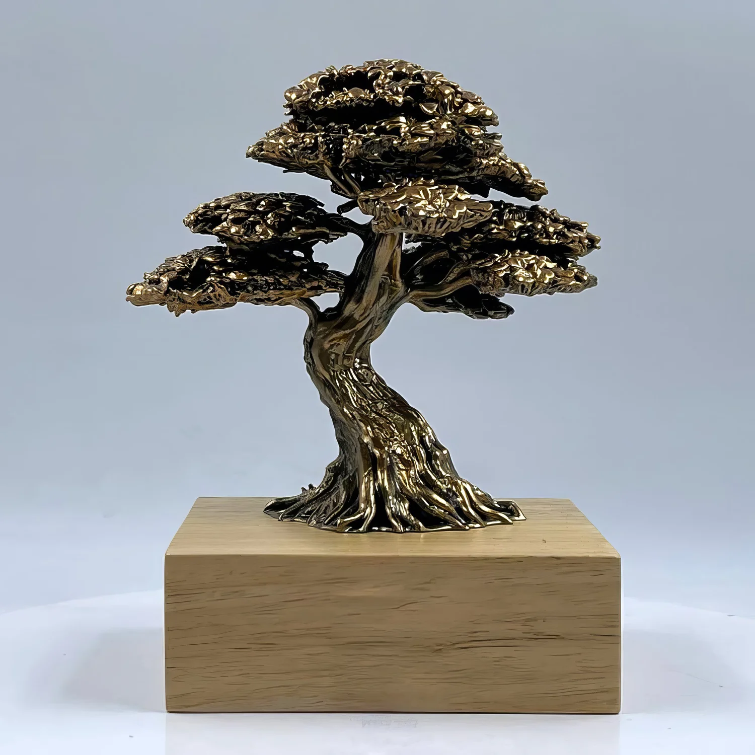 Bronze-colored bonsai tree award with a detailed sculpted trunk on a light wood base.