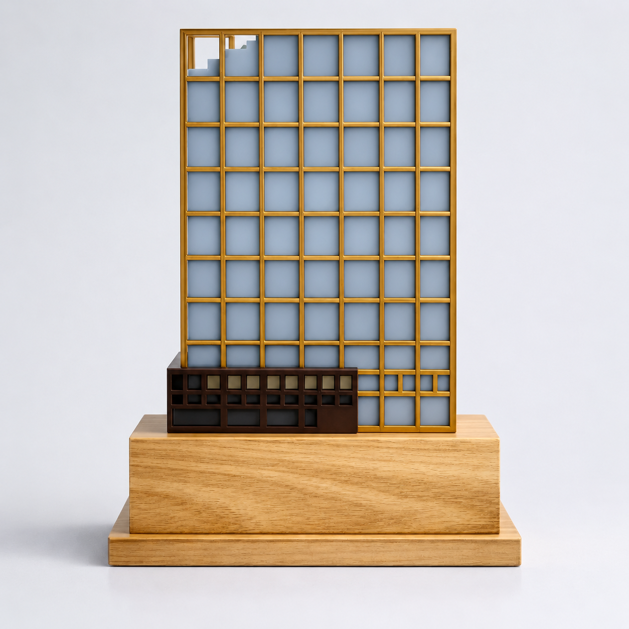 Slate-gray-blue and gold architectural facade model on a stepped natural wood base.