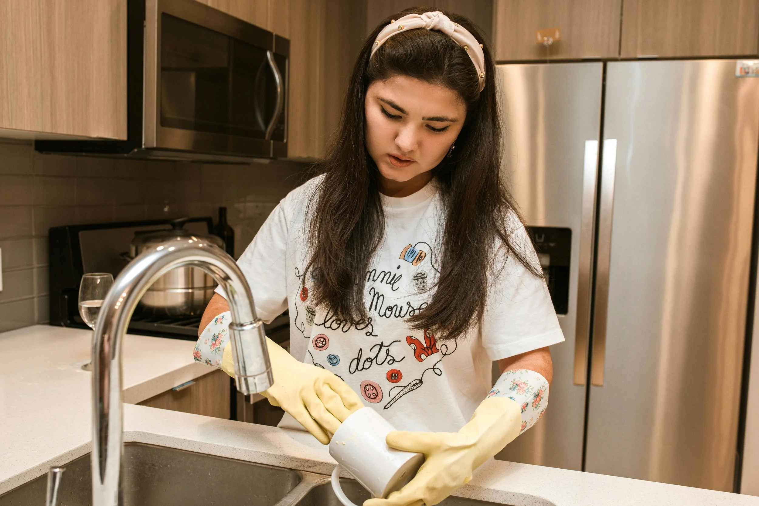 Person cleaning dishes to build productive habits