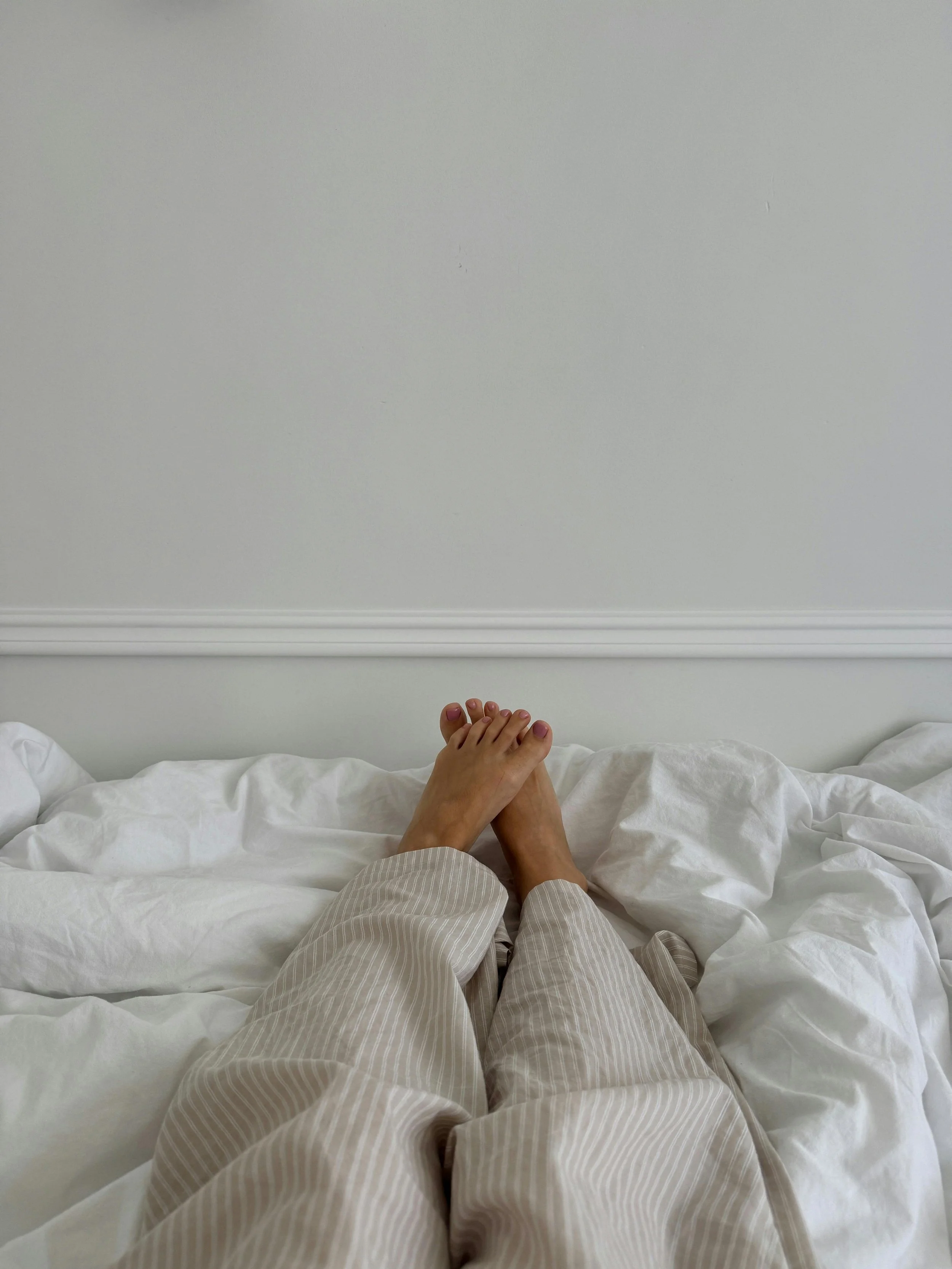 Person laying in bed doing progressive muscle relaxation