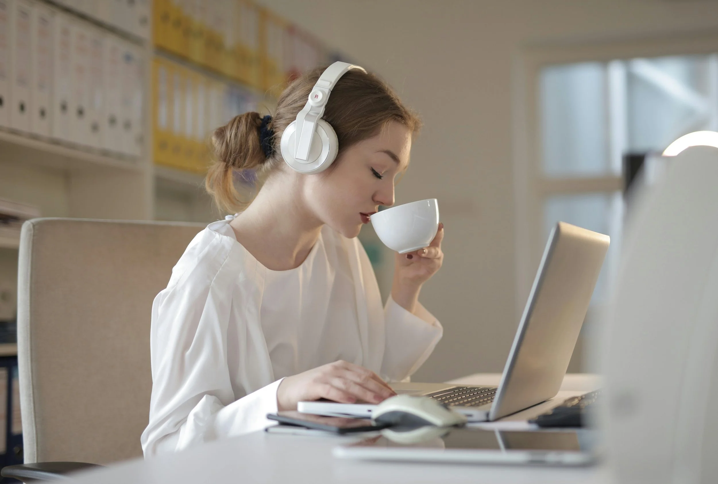 Woman drinking coffee and listening to music