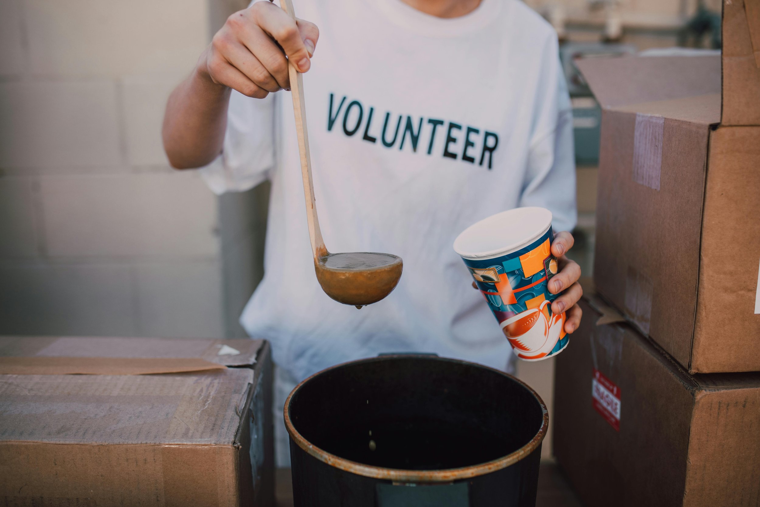 Person volunteering at a soup kitchen