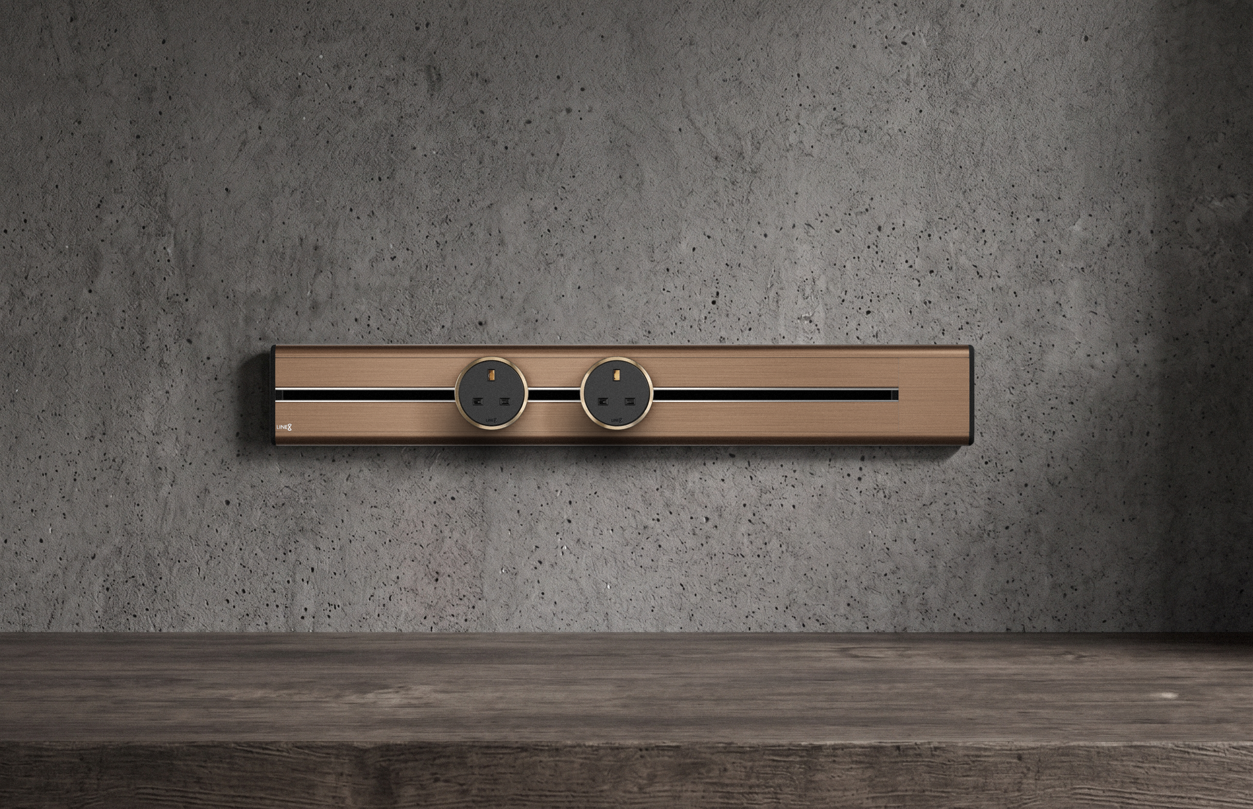 Premium Line8 Model SL electrical power track showcasing an elegant brushed Rosegold finish. Mounted against a textured, industrial-chic concrete wall, the high-end architectural fitting features a contrasting black center channel and includes two circular black power adaptors, positioned perfectly above a rustic, dark wood surface.