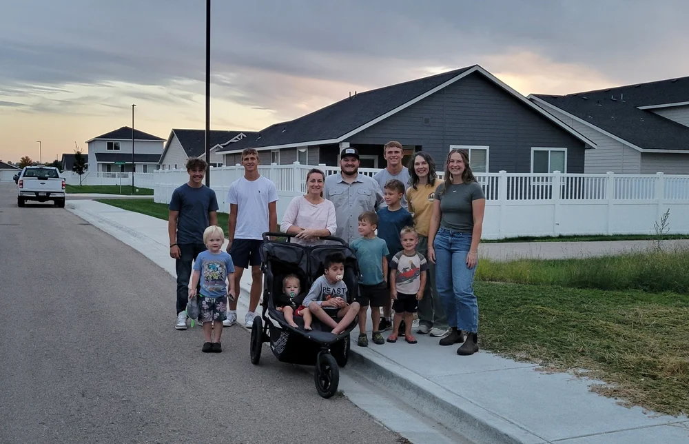 PBC friends and families gathered outside a home.