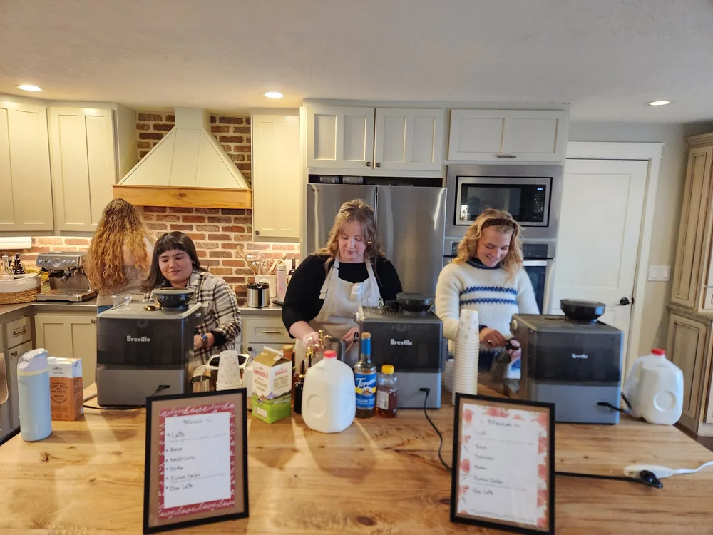Friends working together around a kitchen table.