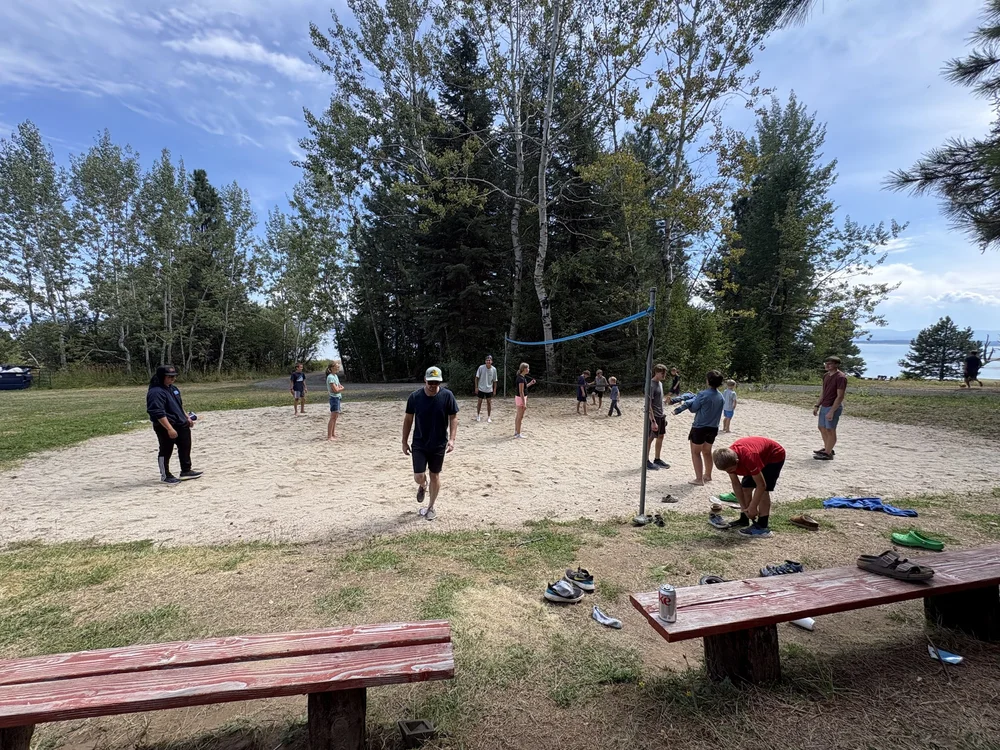 PBC friends playing volleyball outdoors.