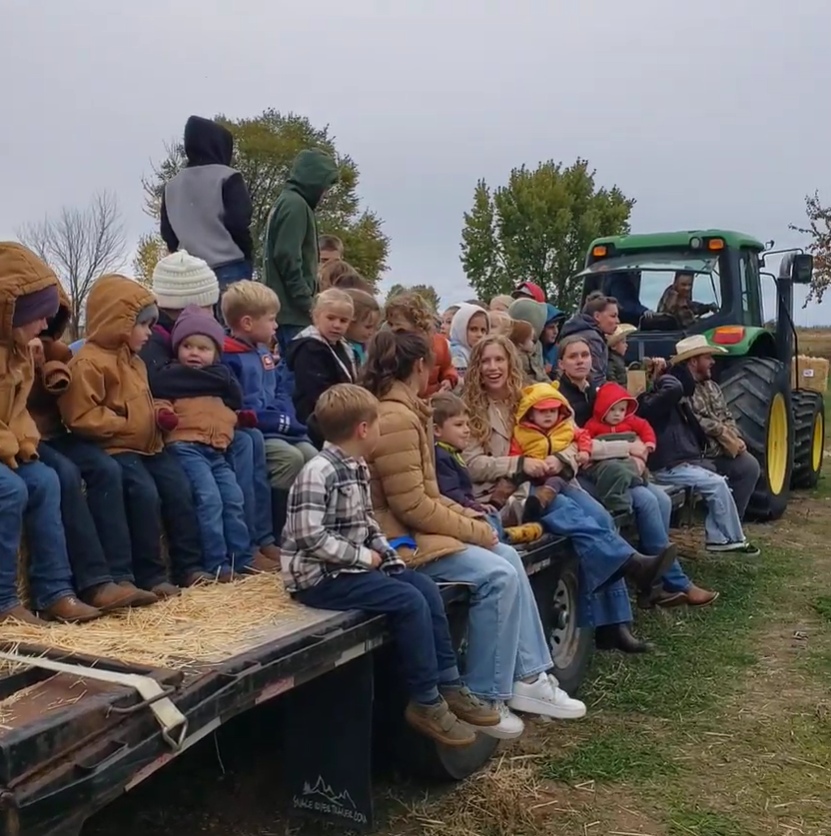 Families enjoying an autumn hayride.