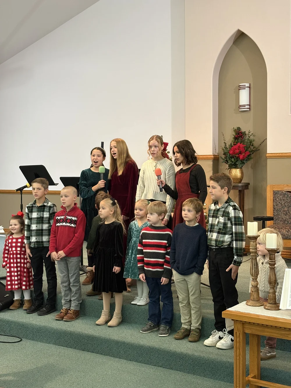 Children singing at the front of the church.
