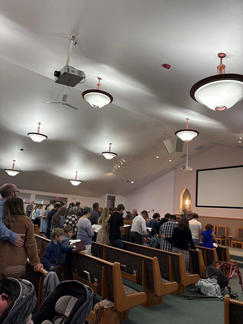 The congregation standing together for worship.