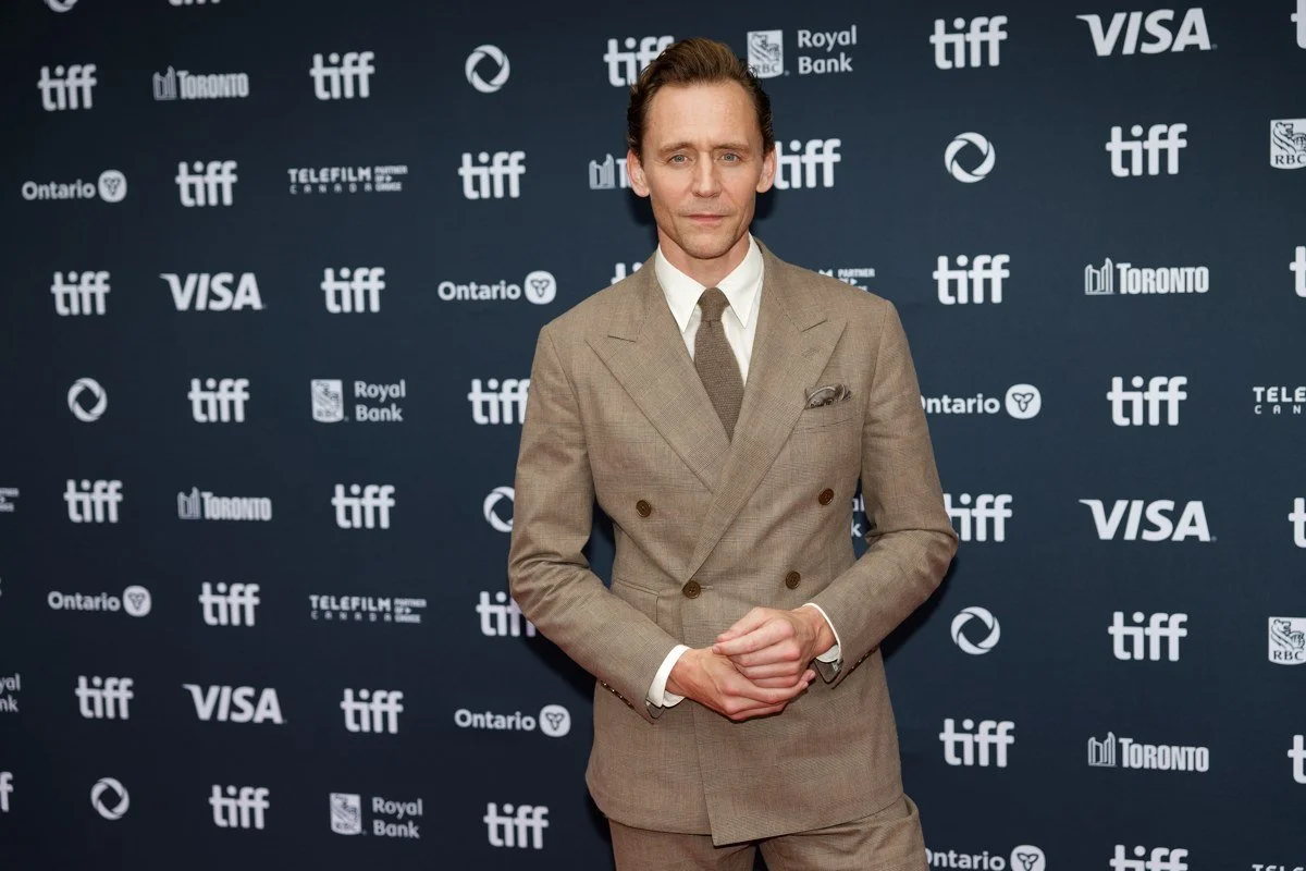 Tom Hiddleston wearing a tan suit at the 2024 Toronto International Film Festival.