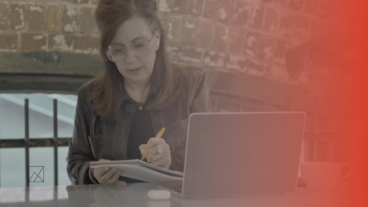 Real estate coaching call planning session with a laptop and notes