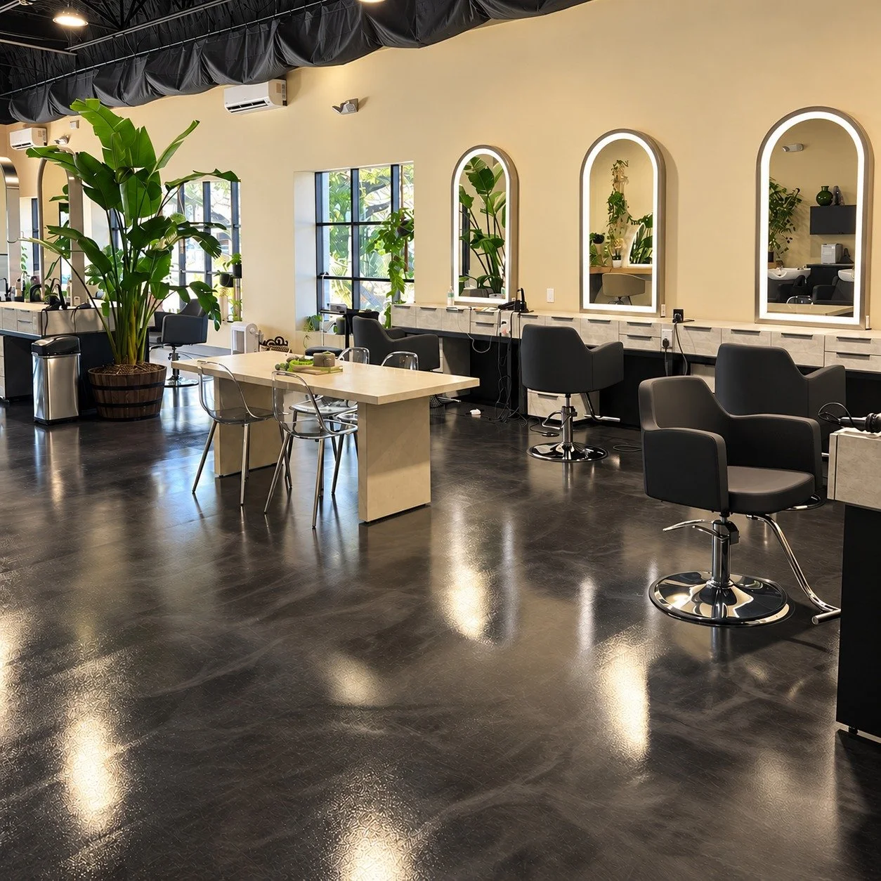 Inside Soultuary Salon in Sarasota with arched mirrors, styling chairs and plants