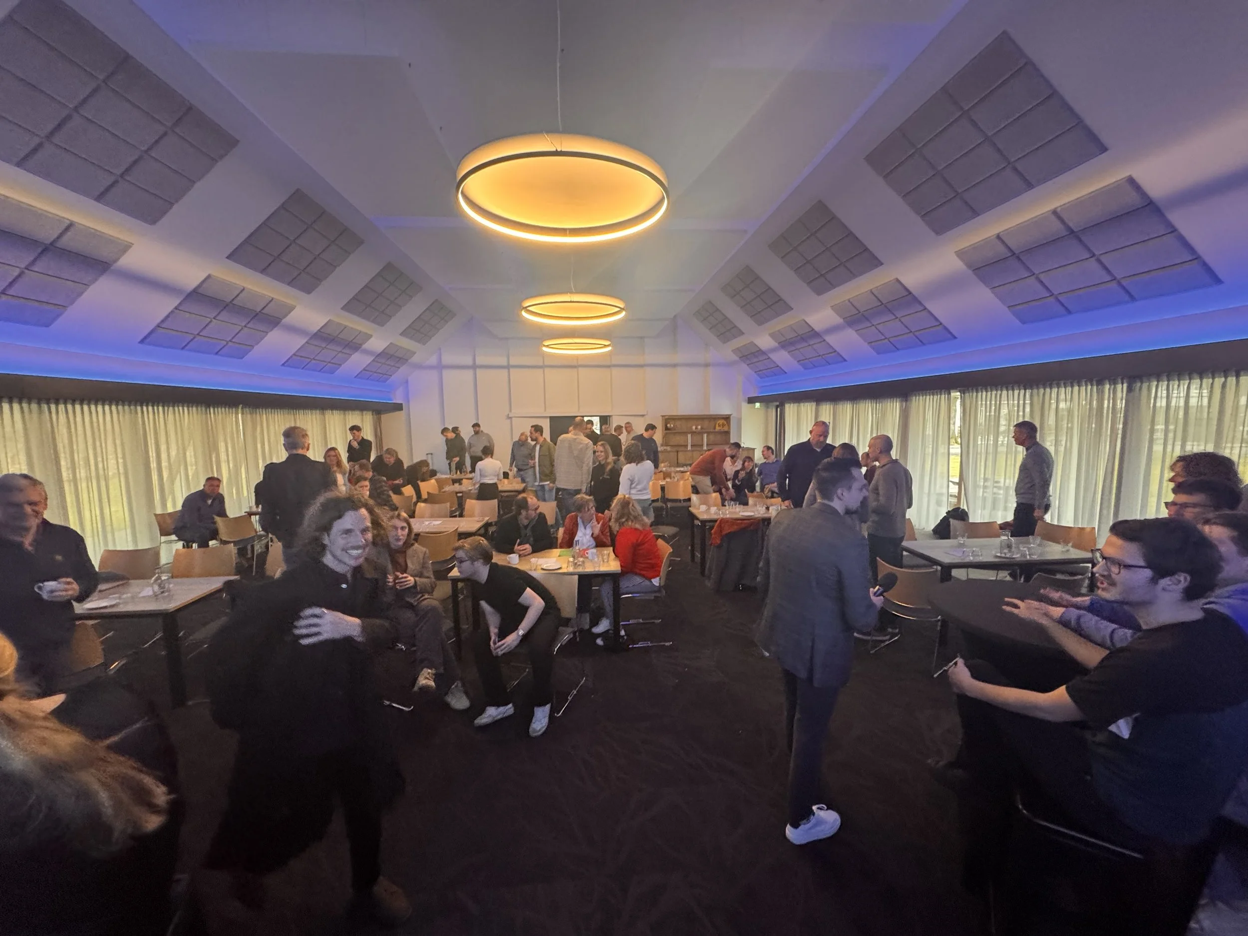 Een zaal met deelnemers die meedoen tijdens een sessie van Maarten Brand