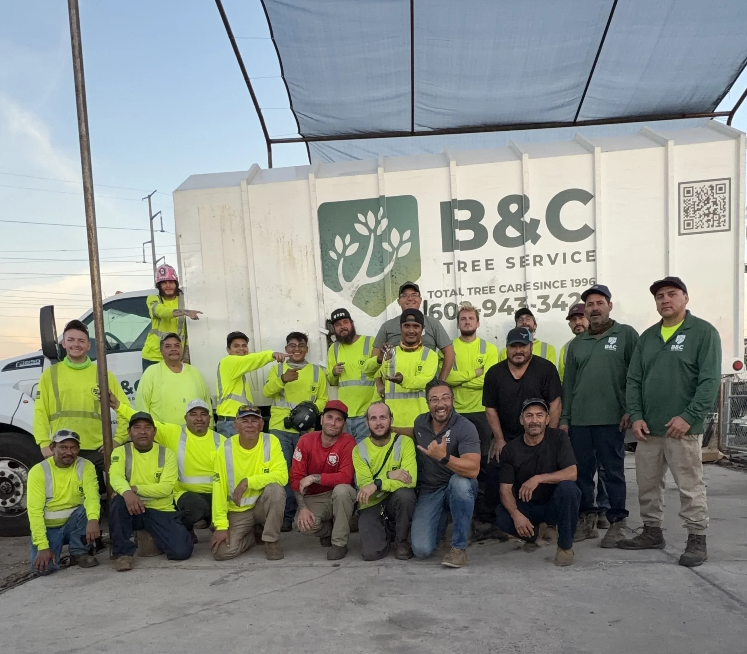 The B&C Tree Service crew gathered in front of a branded work truck in Arizona