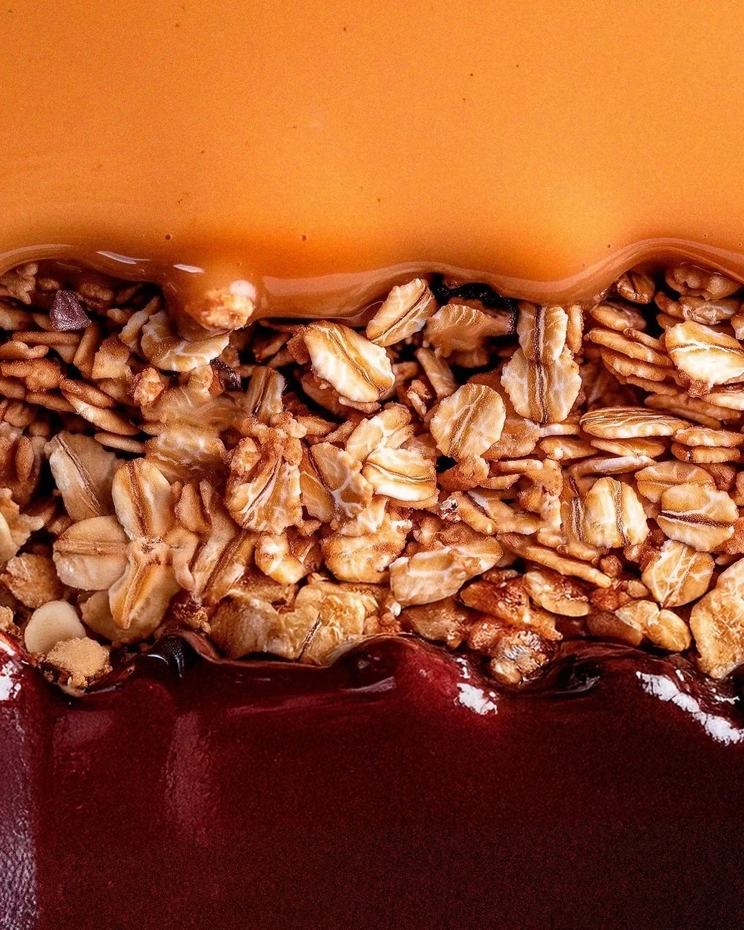 Close-up of peanut butter, granola and açaí layers.