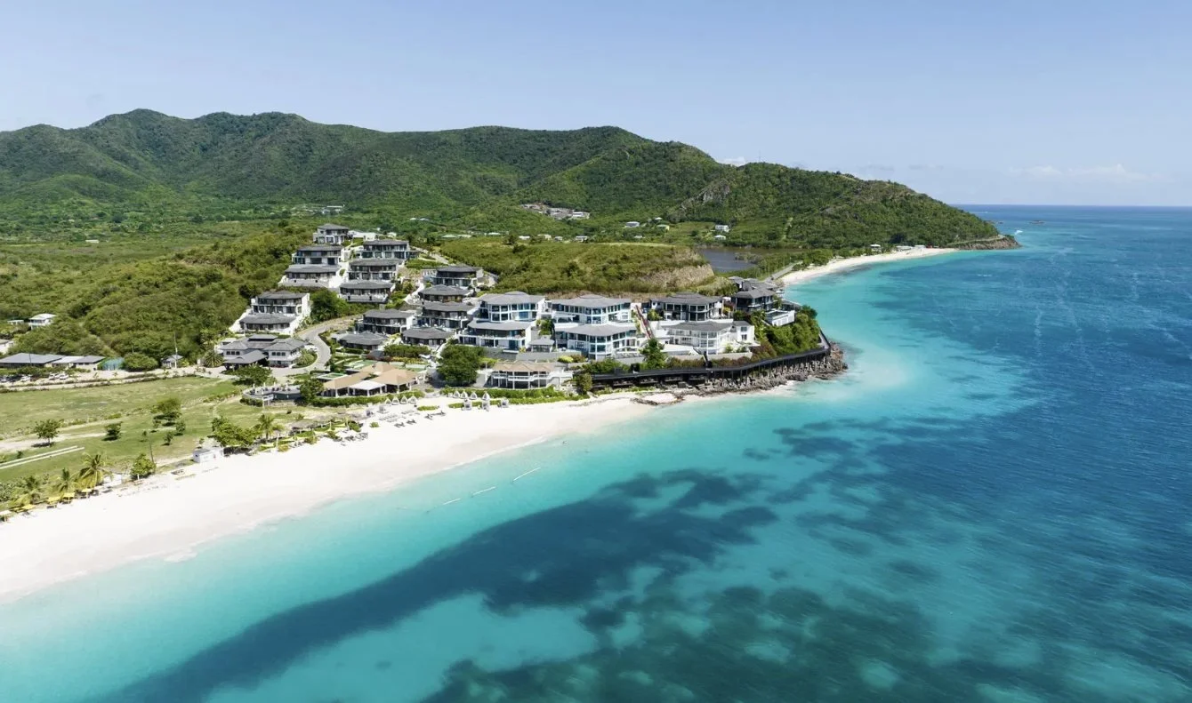 The resort and white sand bay from the air