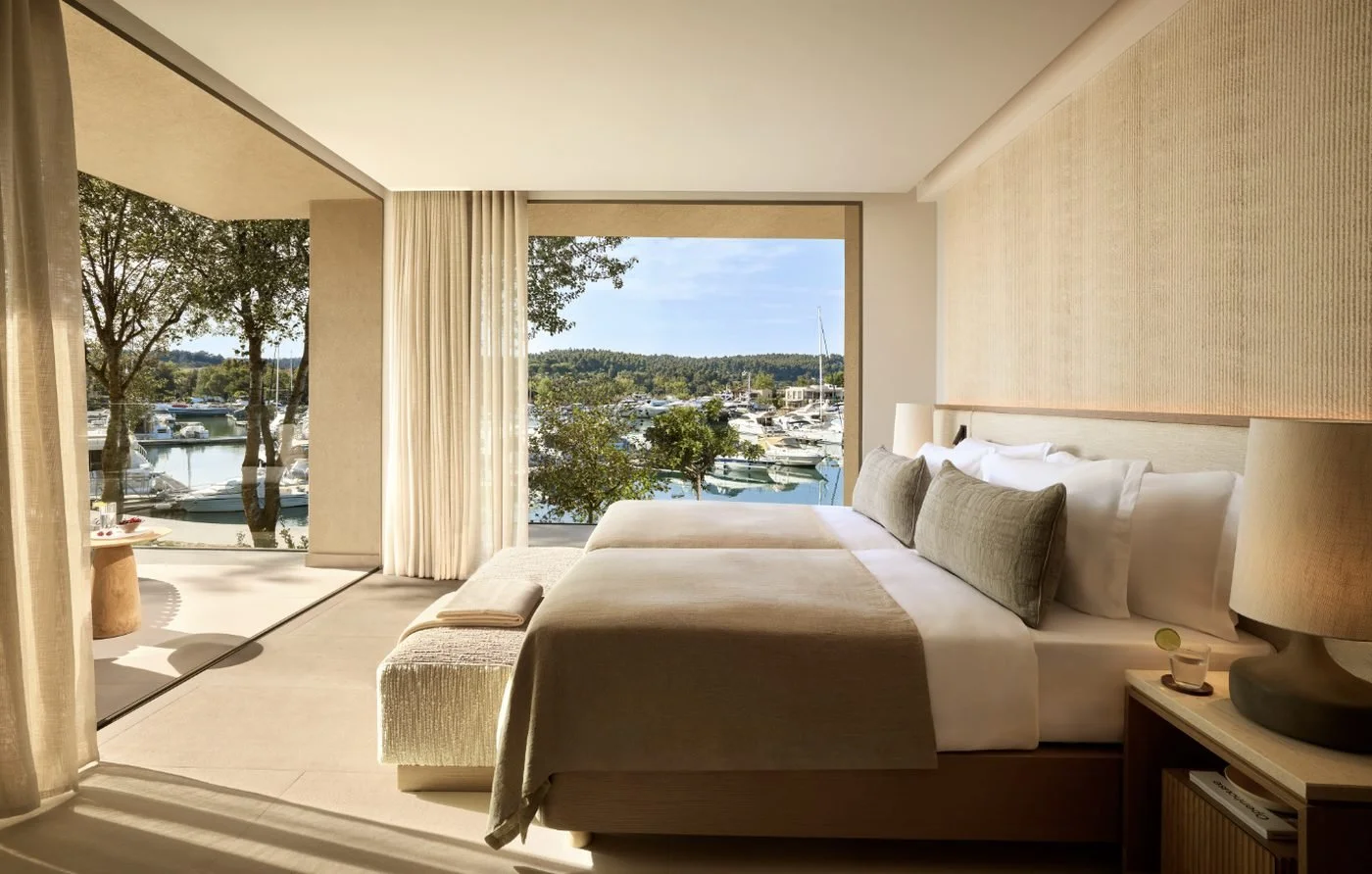 Bedroom in a two-bedroom residence at Sani Asterias with floor-to-ceiling windows over Sani Marina