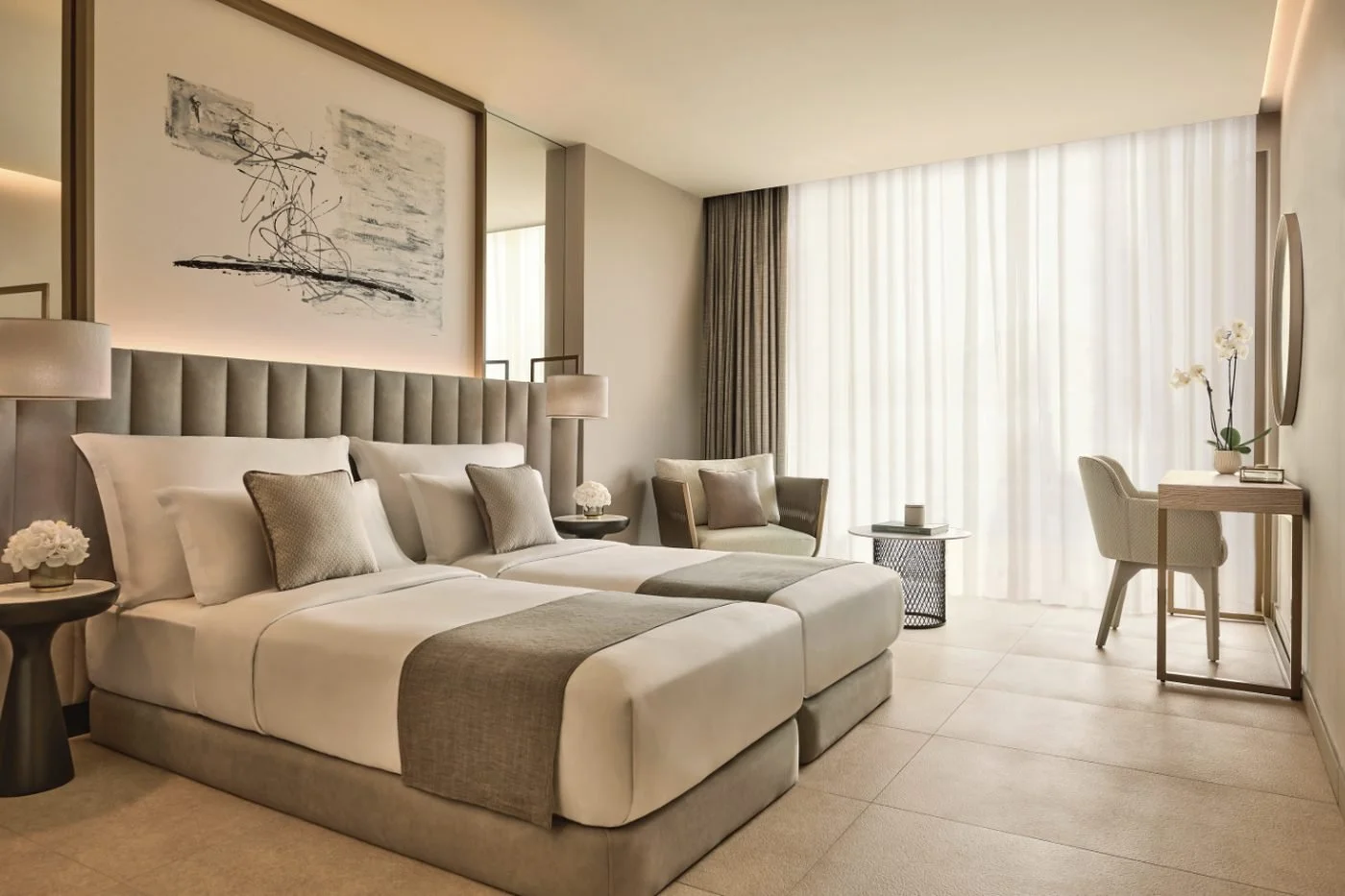 A Double Room at Ikos Andalusia with two single beds, an upholstered headboard and sheer curtains