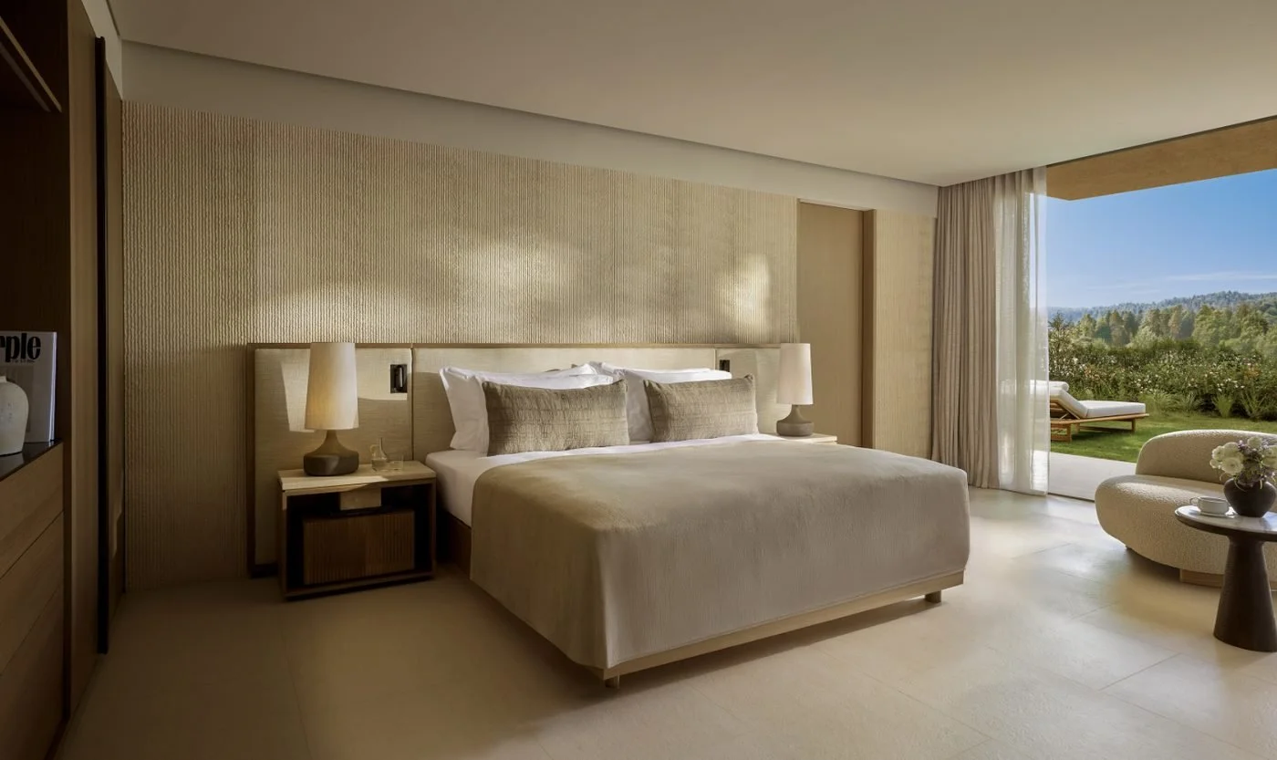 Bedroom in a two-bedroom residence at Sani Asterias opening onto a lawn and pine-covered hills