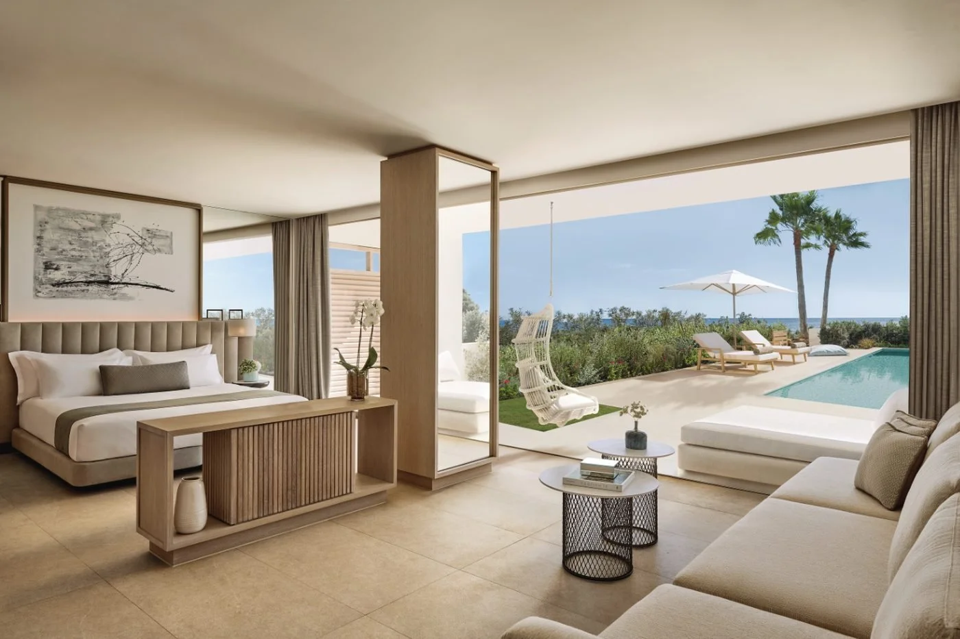A Deluxe Junior Suite Private Pool opening onto a terrace with a hanging chair, loungers and its own pool