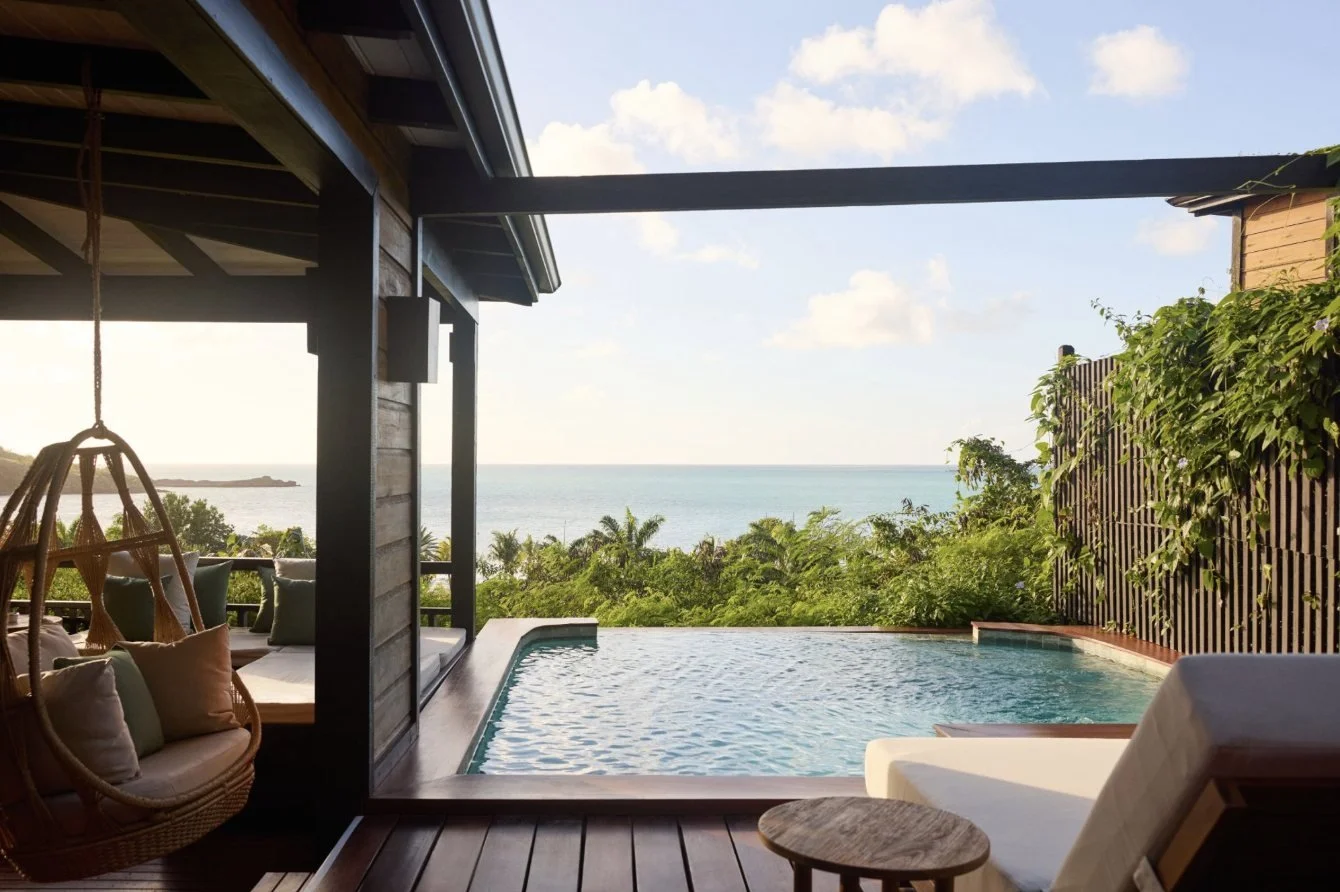 A hillside villa pool deck with sea views