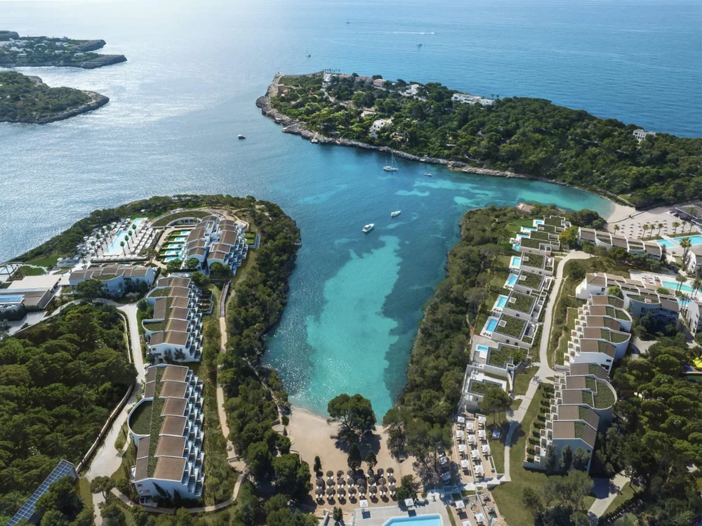 Aerial view of Ikos Porto Petro around a turquoise cove on Mallorca