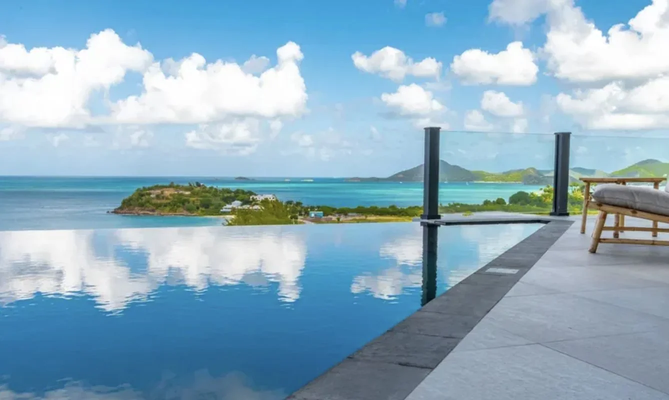 An infinity pool looking over turquoise sea and islands