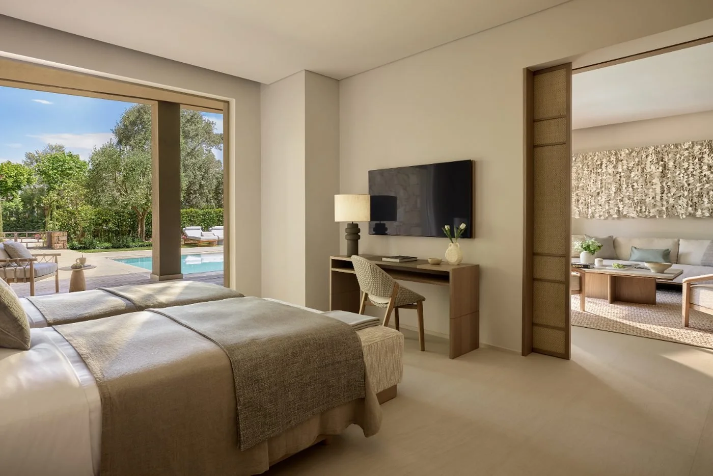 Twin bedroom in a three-bedroom residence at Sani Asterias, opening onto a private pool and garden