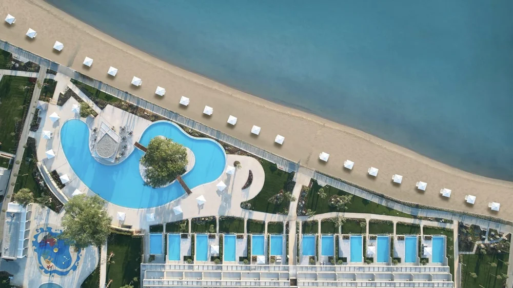 Aerial view of the beach, pools and private-pool suites at Ikos Dassia