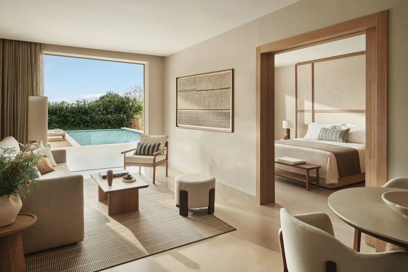 The living area of a Deluxe One Bedroom Bungalow Suite Private Pool at Ikos Olivia opening onto its own pool
