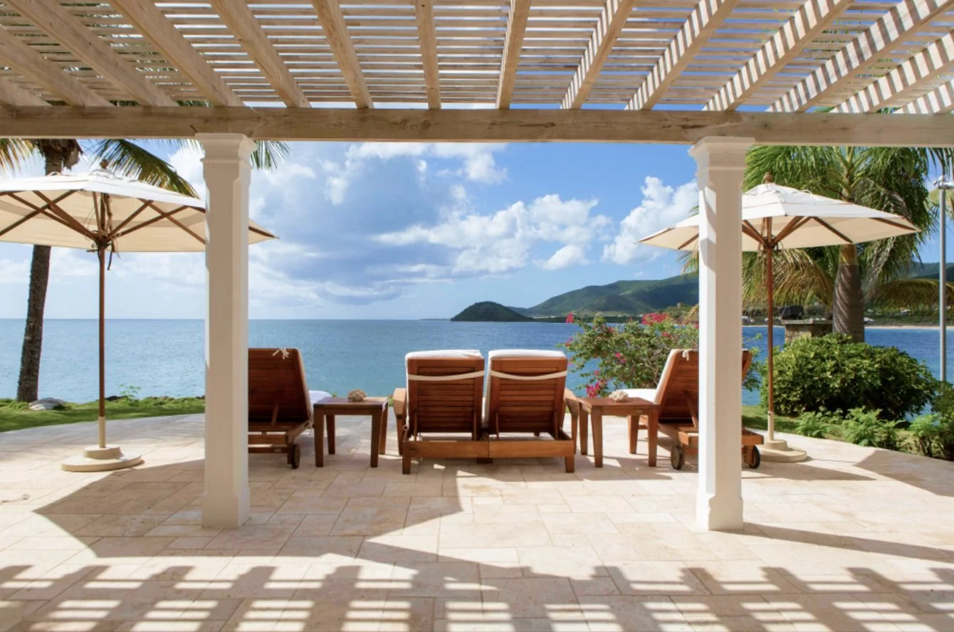 A sea-view spa terrace with loungers