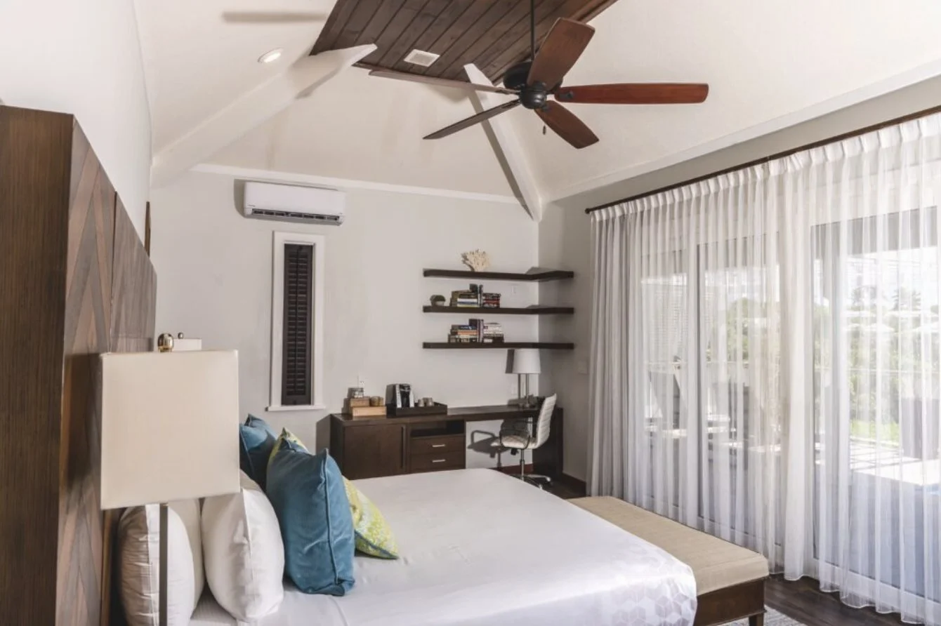 A Waterview Villa bedroom with sheer curtains