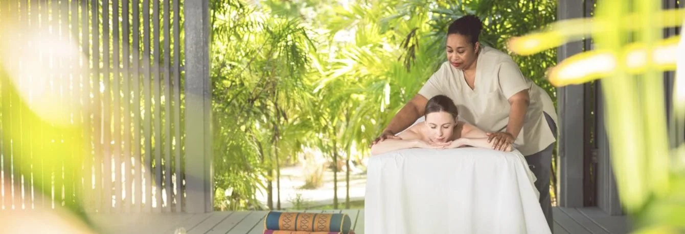 An outdoor massage in a garden pavilion at CARA Spa
