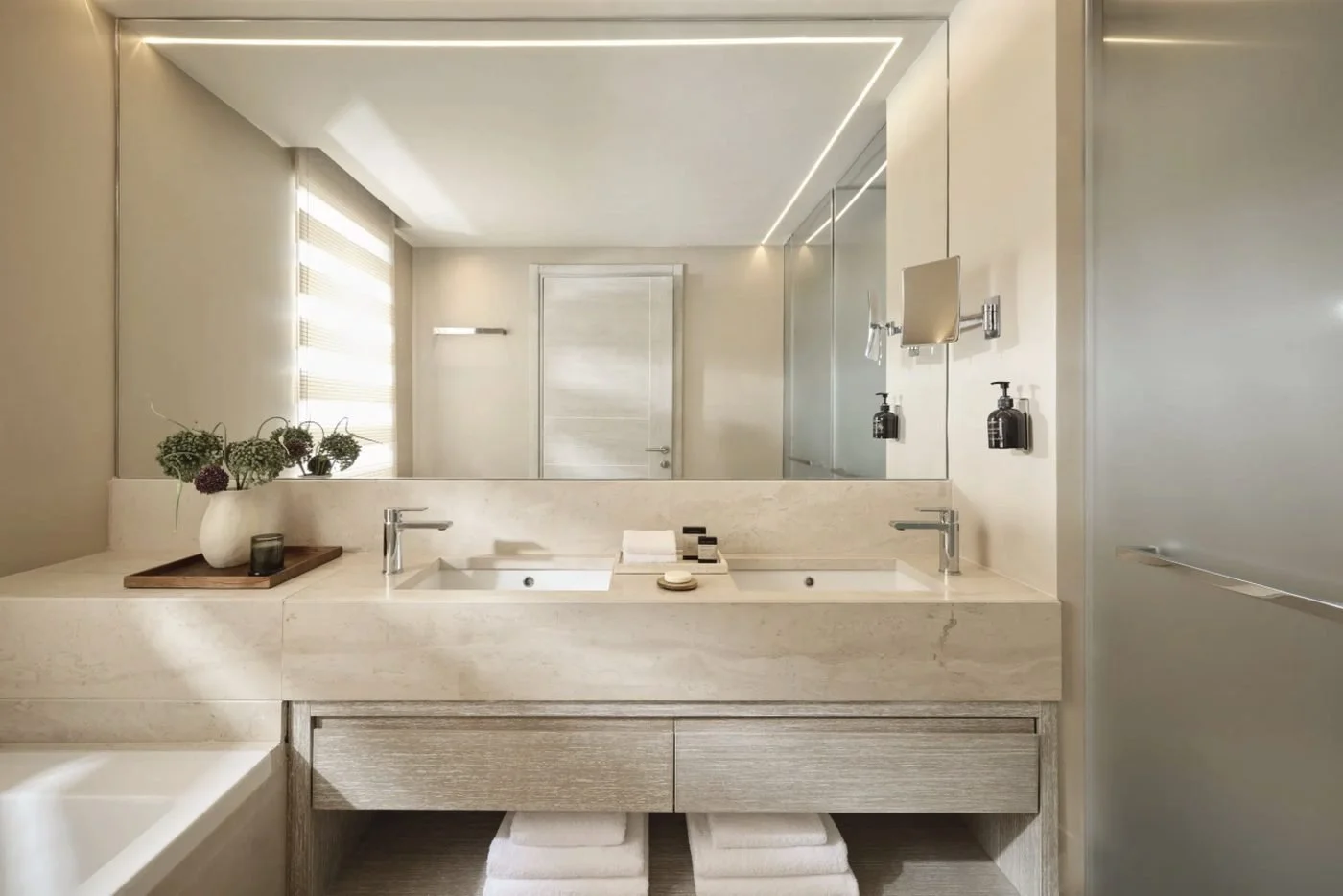 The bathroom of a Family Room Pool View, with twin basins in a stone vanity and a bath