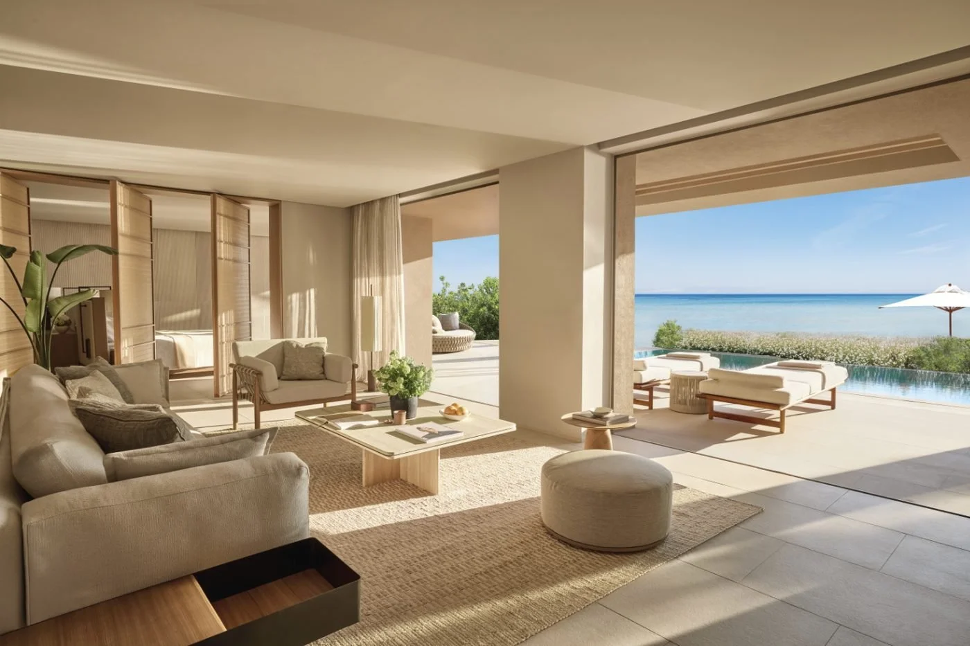 Open-plan living room of a signature residence at Sani Asterias with a terrace, an infinity pool and the sea
