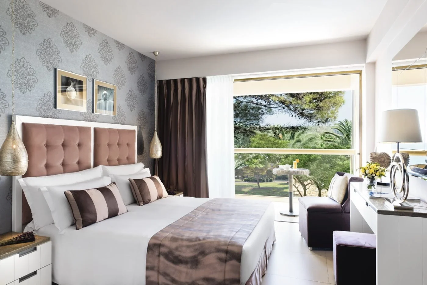 A double room at Sani Beach opening onto a balcony over the gardens; the Family Room joins two rooms like this