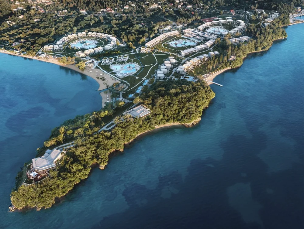 Aerial view of Ikos Odisia spread across a wooded headland on Corfu