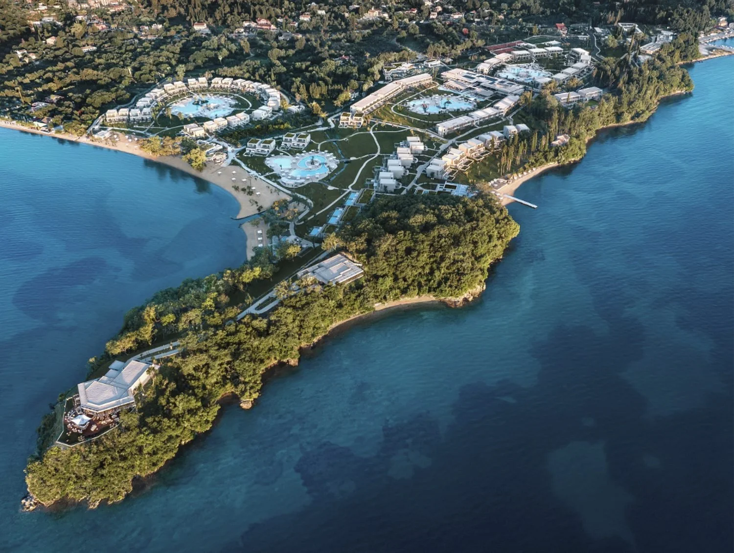Aerial view of Ikos Odisia spread across a wooded headland on Corfu