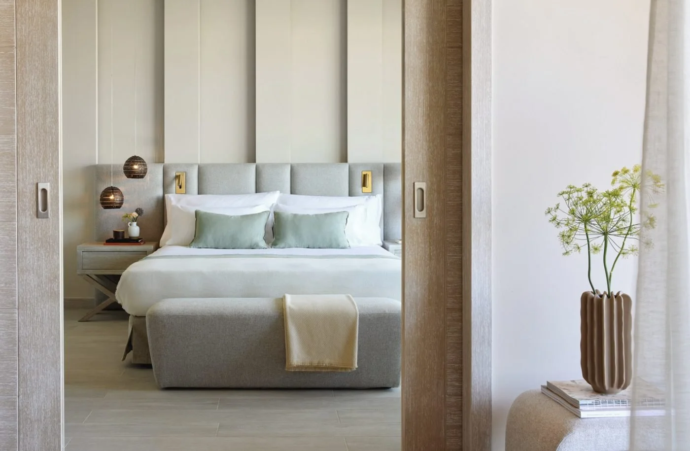 The bedroom of a One Bedroom Suite seen through open sliding doors